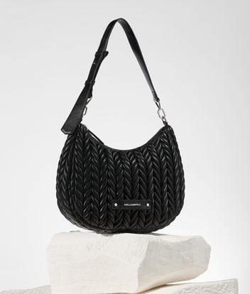 Black textured handbag on a light gray background