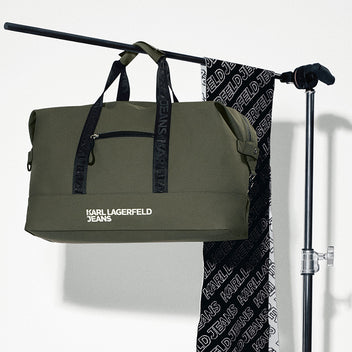 Green duffel bag with 'Karl Lagerfeld Jeans' branding on a white background