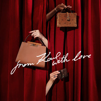 Three bags held by hands against a red curtain with 'From Karl with love' text.